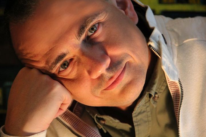 Man staring with a tilted face resting on his fist