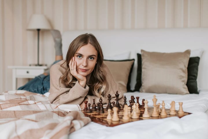Pretty woman with a chess board