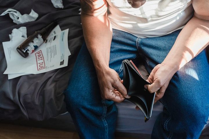 Man checking his empty wallet