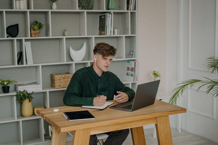 Man with airpods working at his desk