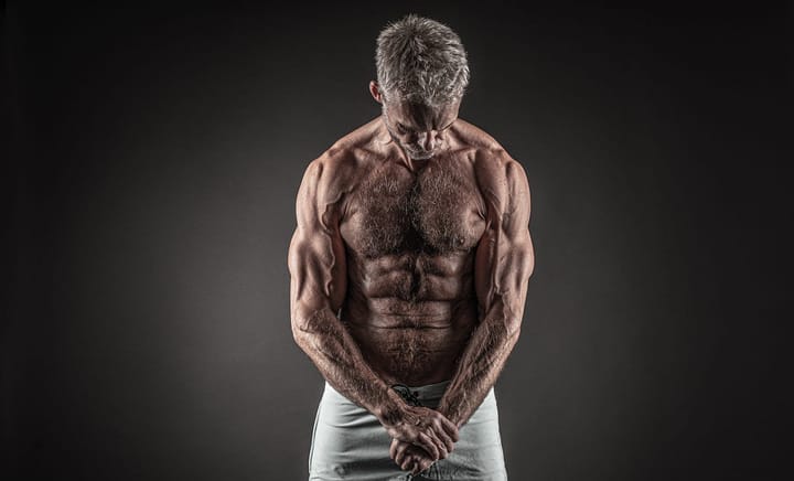 Pepper-haired muscular and ripped old man flexing