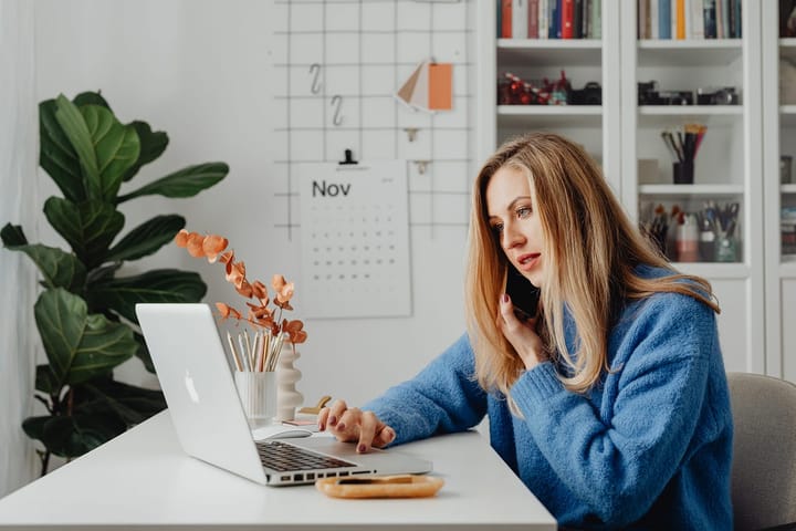 Pretty blonde woman working with her macbook