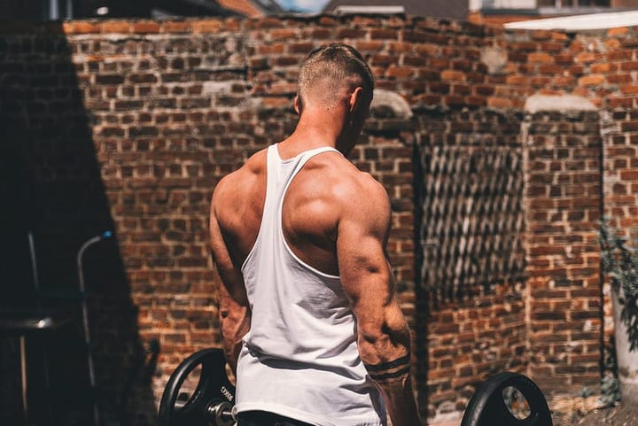 Muscular man working out in a tank top