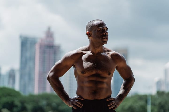 Muscular black man standing akimbo