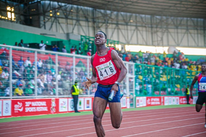 Muscular black sprinter during a relay race