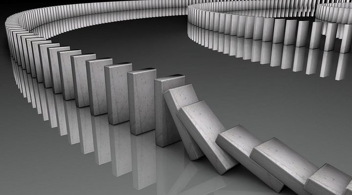 Black and white photo of tumbling dominoes