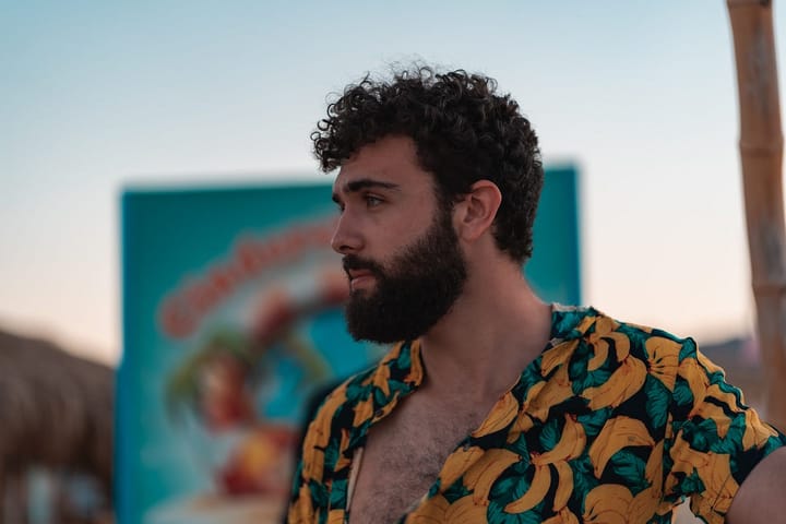 Serious looking bearded man in a hawaian shirt