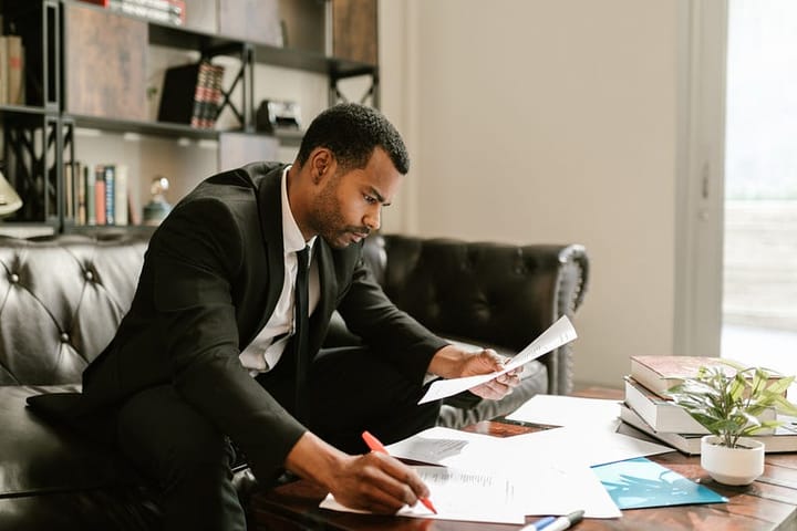 Well-groomed formally-dressed man working intensely